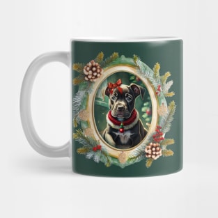 A cute black puppy dog wearing a festive bow and dog collar, in a winter Christmas picture frame with pinecones and winter berries Mug